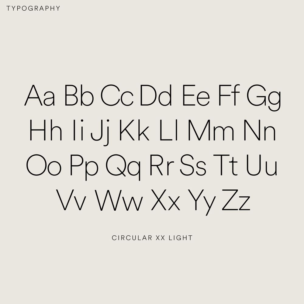Graphic of a typography specimen showing the alphabet and numerals on top of a dark gray background.